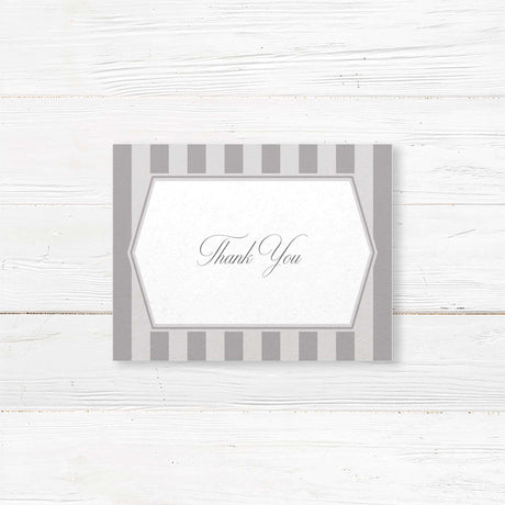 Gray thank you card with vertical stripes, white panel, and monogram crest