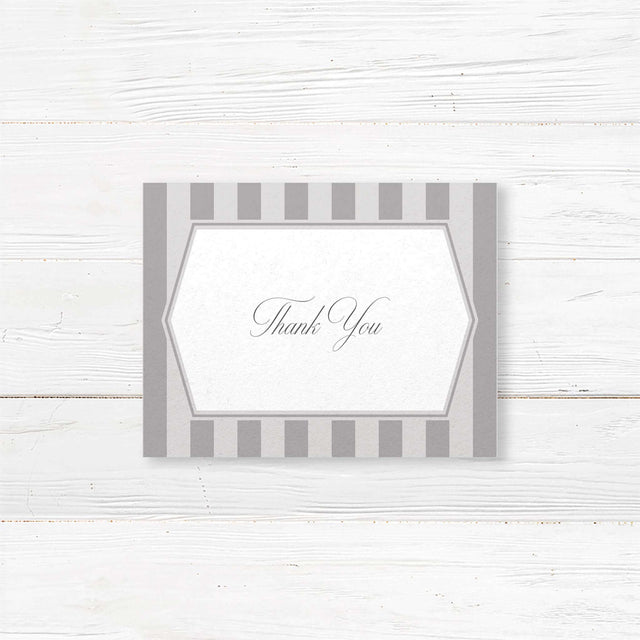 Gray thank you card with vertical stripes, white panel, and monogram crest