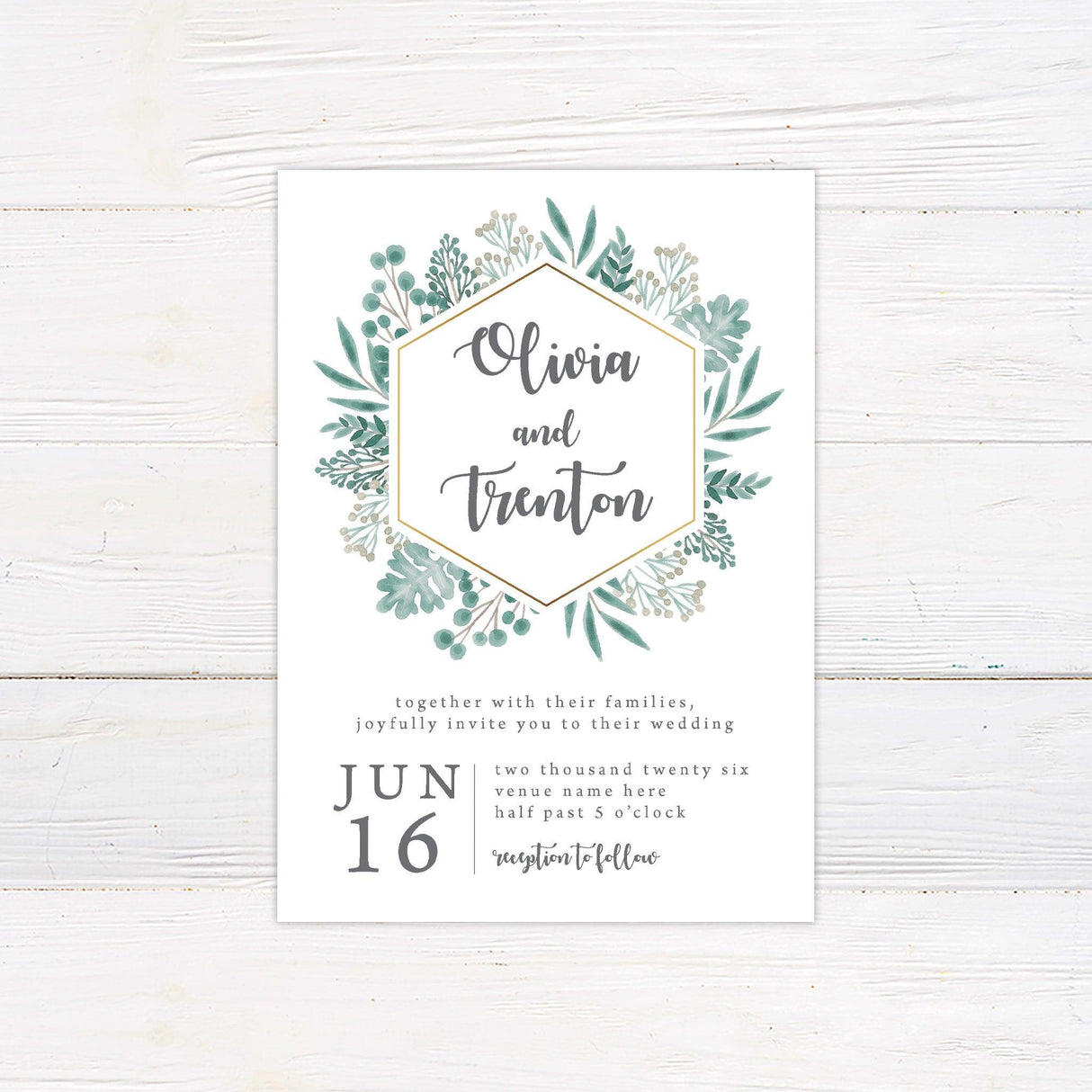 A wedding invitation with a white background features a modern hexagonal frame accented with a gold outline, surrounded by lush watercolor greenery. The couple’s names are displayed in elegant script inside the frame, while the event details, including the date, time, and venue, are arranged in a stylish serif and script font combination below. This design exudes a fresh, botanical feel, perfect for nature-inspired, rustic, or minimalist weddings.