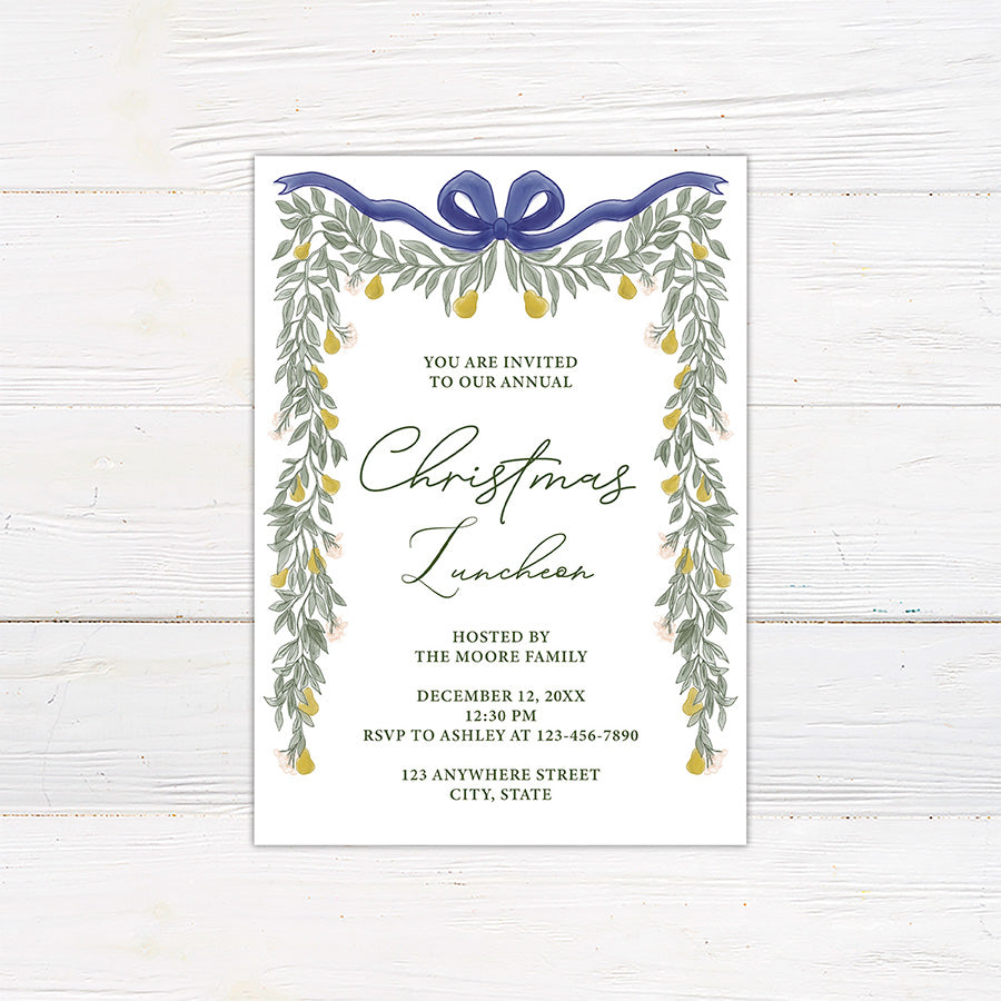 Elegant pear greenery Christmas luncheon invitation framed with watercolor greenery, golden pears, delicate flowers, and a navy bow. The invitation includes personalized host, date, RSVP, and event location information.