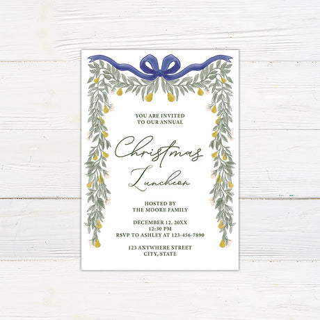 Elegant pear greenery Christmas luncheon invitation framed with watercolor greenery, golden pears, delicate flowers, and a navy bow. The invitation includes personalized host, date, RSVP, and event location information.