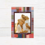 Personalized Christmas photo card featuring a family picture surrounded by a colorful painted plaid border. The back includes additional family photos and space for a custom holiday message.