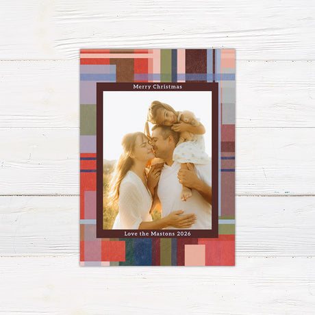 Personalized Christmas photo card featuring a family picture surrounded by a colorful painted plaid border. The back includes additional family photos and space for a custom holiday message.