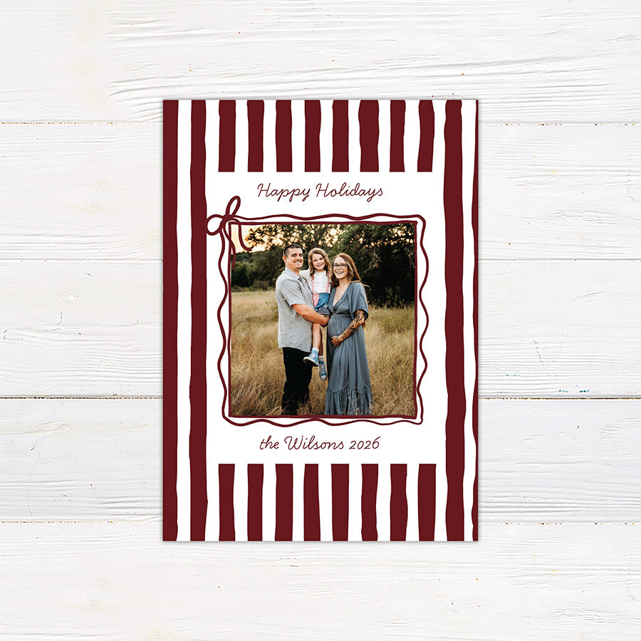 Personalized family holiday photo card featuring a bold hand-drawn striped border and centered family photograph. red