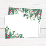 Winter holly berry bridal shower invitation featuring watercolor evergreen greenery, leafy branches, and bright red berries. The coordinating back continues the botanical design with greenery and red berry accents on a white background. - back.