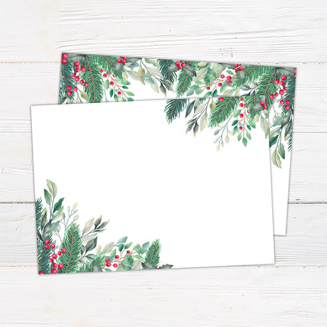 Winter holly berry bridal shower invitation featuring watercolor evergreen greenery, leafy branches, and bright red berries. The coordinating back continues the botanical design with greenery and red berry accents on a white background. - back.