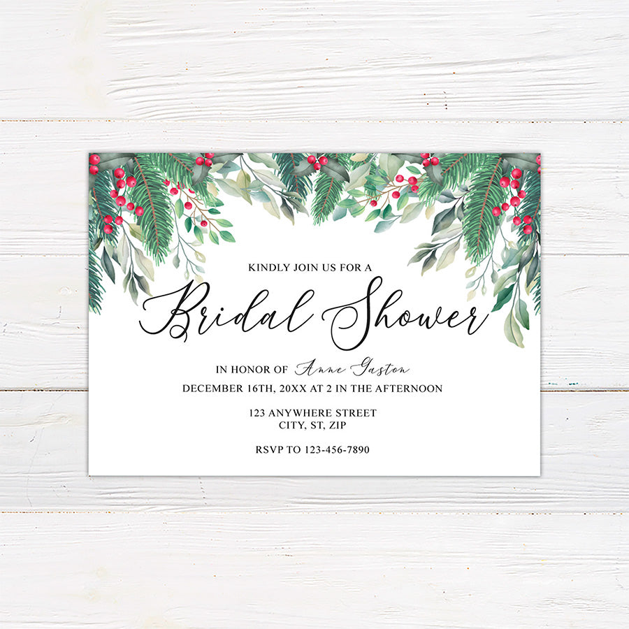 Winter holly berry bridal shower invitation featuring watercolor evergreen greenery, leafy branches, and bright red berries. The coordinating back continues the botanical design with greenery and red berry accents on a white background.