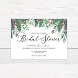 Winter holly berry bridal shower invitation featuring watercolor evergreen greenery, leafy branches, and bright red berries. The coordinating back continues the botanical design with greenery and red berry accents on a white background.