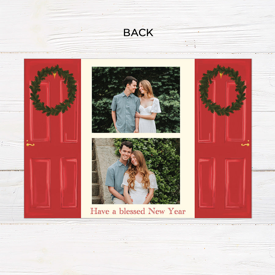 Personalized Home for the Holidays Christmas gatefold photo card featuring festive red double doors decorated with evergreen wreaths and customizable family photos. The folding holiday card opens to reveal a large photo and personalized Christmas greeting with an additional four-photo collage. Two-photo variant. - back