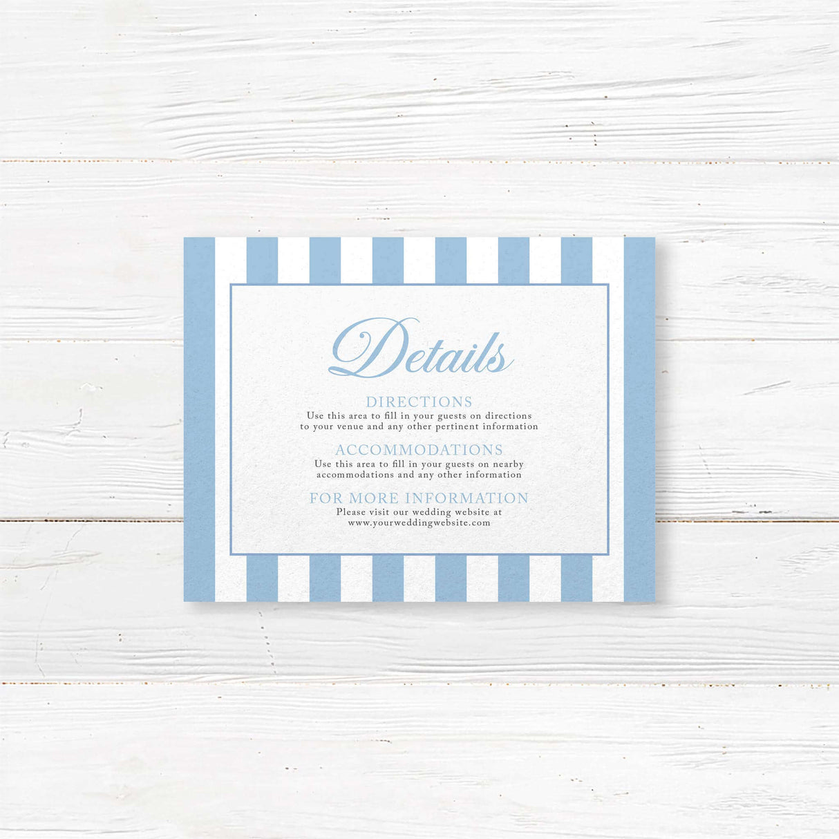 Printed wedding detail card with powder blue and white vertical stripes, white background, elegant serif text, and coordinating floral monogram crest, part of the Hydrangea Crest suite.