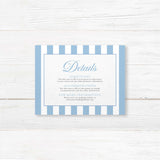 Printed wedding detail card with powder blue and white vertical stripes, white background, elegant serif text, and coordinating floral monogram crest, part of the Hydrangea Crest suite.