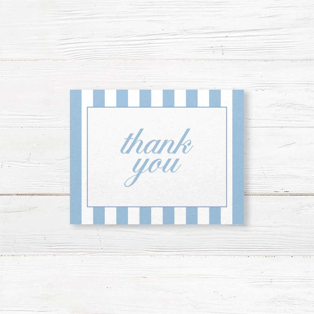 Wedding thank you card with floral monogram crest of blue hydrangeas, powder blue and white vertical stripes, and romantic serif and script fonts matching Hydrangea Crest suite.