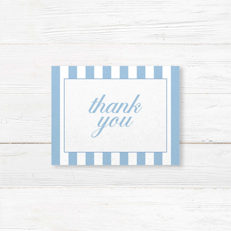 Wedding thank you card with floral monogram crest of blue hydrangeas, powder blue and white vertical stripes, and romantic serif and script fonts matching Hydrangea Crest suite.