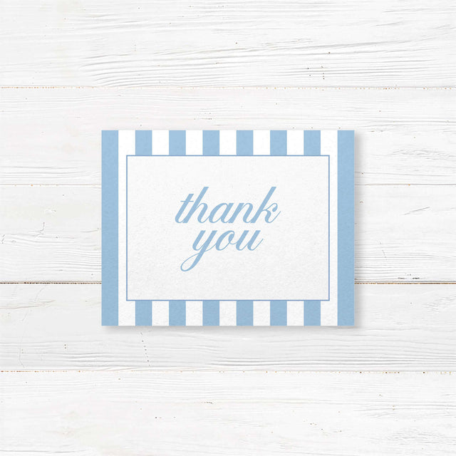 Wedding thank you card with floral monogram crest of blue hydrangeas, powder blue and white vertical stripes, and romantic serif and script fonts matching Hydrangea Crest suite.