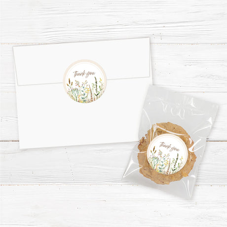 "A set of 2-inch round stickers with a soft, neutral background. The design may feature elegant script or serif text, such as ‘Thank You,’ ‘Diaper Raffle,’ or a baby shower-related message. Decorative elements like delicate florals, watercolor greenery, or whimsical baby-themed illustrations enhance the aesthetic. The stickers are designed to complement a baby shower theme, perfect for sealing envelopes, favor packaging, or adding a personalized touch to gifts."