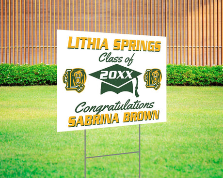 Graduation yard sign with bold text, custom school logo, class year, and congratulatory message. Features a large mortarboard cap graphic and varsity-style font. Printed on durable Coreplast plastic, perfect for outdoor display in front yards, driveways, and school events. Lithia Springs

