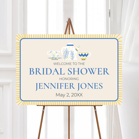 Bridal shower welcome sign featuring blue and gold teapot and teacup illustrations, printed on high-quality material for a refined tea party event.