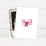 Personalized Christmas photo card featuring a family portrait framed by watercolor mistletoe, greenery, berries, and ribbon bows. The back features a coordinating watercolor bow.