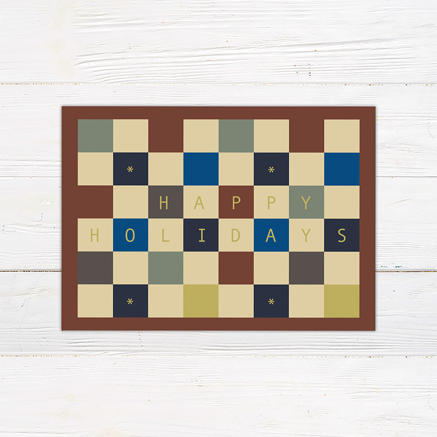 Personalized holiday card featuring a geometric color block pattern with a Happy Holidays greeting and custom family details. Coordinating options include a family photo layout and personalized seasonal message.