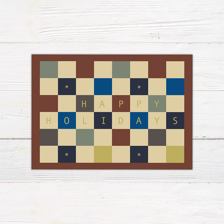 Personalized holiday card featuring a geometric color block pattern with a Happy Holidays greeting and custom family details. Coordinating options include a family photo layout and personalized seasonal message.