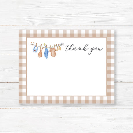 Printed baby shower thank you card featuring a soft watercolor baby clothesline with adorable blue baby rompers, bibs, and socks. Designed with elegant script text for a heartfelt message. Printed on thick, high-quality cardstock, available in folded or flat options. Ideal for sending appreciation after a baby shower, gender reveal, or baby sprinkle. Complements a rustic, boho, or vintage baby shower theme while adding a meaningful touch.