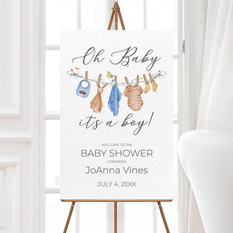 Printed baby shower welcome sign featuring a soft watercolor baby clothesline with blue baby outfits, bibs, and socks. Professionally printed on thick poster paper, available in multiple sizes. Ideal for greeting guests at a baby boy shower, gender reveal, or baby sprinkle. Matches rustic, boho, or country baby shower themes. A perfect way to set the tone for an elegant and charming baby shower event.