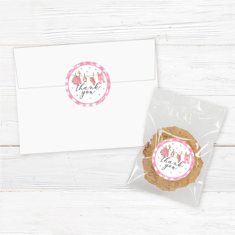 Baby shower favor stickers featuring a pink baby clothesline design. High-quality printed adhesive labels for favor bags, candles, jars, or small gifts.