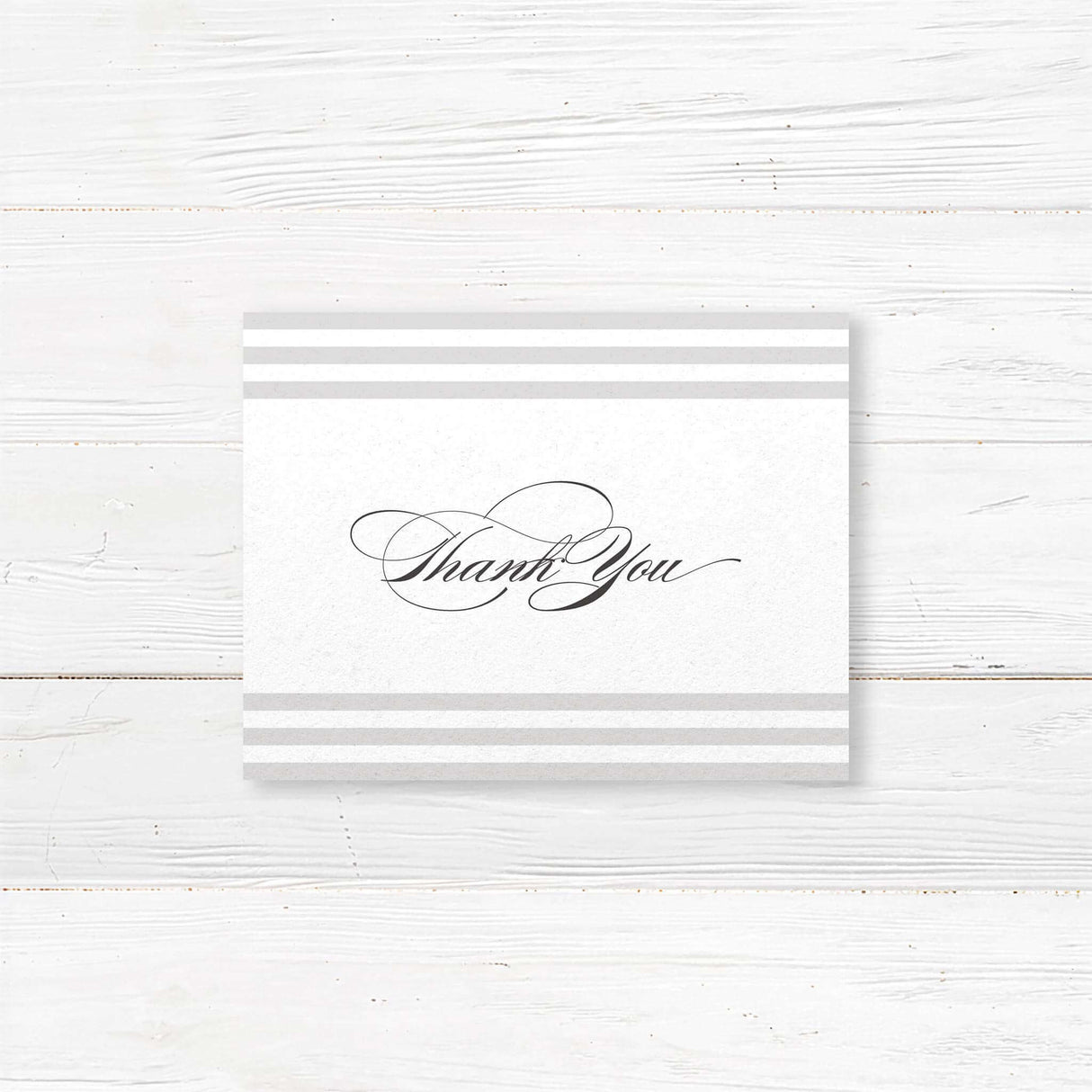 Wedding thank you card with soft horizontal taupe and ivory stripes, elegant serif and flourished script fonts, and minimalist layout, matching Paragraph Style stationery suite.