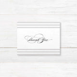 Wedding thank you card with soft horizontal taupe and ivory stripes, elegant serif and flourished script fonts, and minimalist layout, matching Paragraph Style stationery suite.