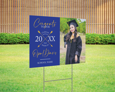 Custom graduation yard sign with a split design, featuring a graduate’s photo on one side and a modern crossed arrows Class Year design with custom school name on the other. Printed on weatherproof Coreplast plastic, available in custom colors and single or double-sided print, perfect for high school and college graduates. Blue