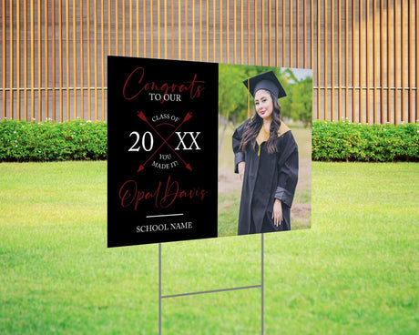 Custom graduation yard sign with a split design, featuring a graduate’s photo on one side and a modern crossed arrows Class Year design with custom school name on the other. Printed on weatherproof Coreplast plastic, available in custom colors and single or double-sided print, perfect for high school and college graduates. Red and black