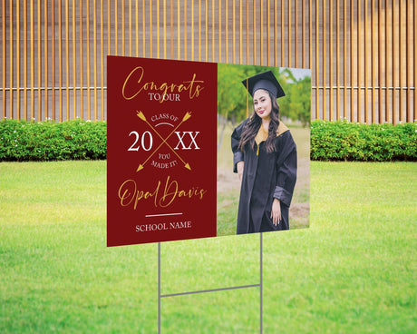 Custom graduation yard sign with a split design, featuring a graduate’s photo on one side and a modern crossed arrows Class Year design with custom school name on the other. Printed on weatherproof Coreplast plastic, available in custom colors and single or double-sided print, perfect for high school and college graduates. Red