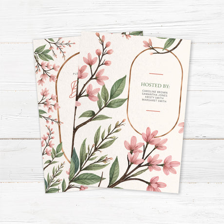 Elegant bridal shower invitation featuring soft pink blossoms, greenery, and a gold arch frame, printed on premium cardstock. Back