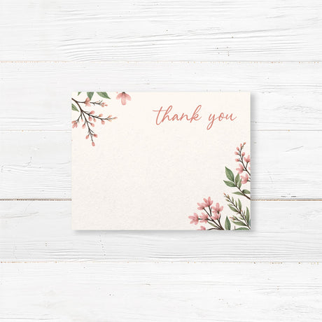 Elegant bridal shower thank-you card featuring soft pink floral blossoms and greenery, printed on premium cardstock for a romantic touch.