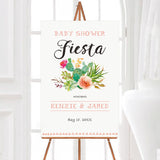 A pink cacti baby shower welcome sign with watercolor cactus and floral artwork. The design uses soft green, peach, and coral colors with modern lettering.