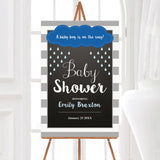 A rain baby shower welcome sign with a cloud and blue raindrops. The design uses blue and gray colors.