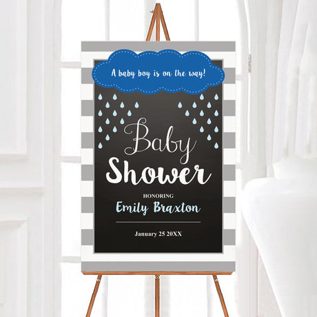 A rain baby shower welcome sign with a cloud and blue raindrops. The design uses blue and gray colors.