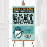 A rock a bye baby shower welcome sign with a penguin holding a guitar and bold lettering. The design uses teal, orange, and black colors with a music theme.