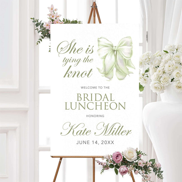 Bridal luncheon invitation welcome sign with sage green watercolor bow and elegant script on textured white background for a tying the knot themed shower