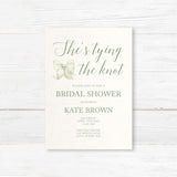 Watercolor bow bridal shower invitation that reads "She’s Tying the Knot" with floral accents,