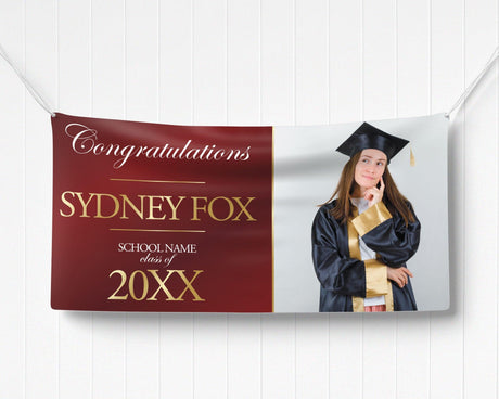 Graduation celebration vinyl banner with a split design featuring a bold congratulatory message in elegant gold text on one side and a proud graduate photo on the other. Made of durable, weatherproof vinyl, perfect for indoor and outdoor graduation party decorations, senior recognition, and high school or college ceremonies. burgundy