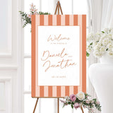 Wedding welcome sign with vertical terracotta and neutral stripes, white center panel, and handwritten script and serif fonts matching the Simply Written wedding suite.