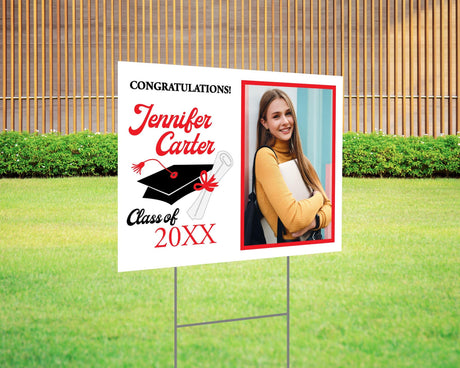 Congratulations graduation yard sign featuring a split design with a side photo, bold script name, mortarboard cap, and diploma graphic, along with the class year and school name in gold accents. Printed on durable Coreplast plastic, available in custom colors and single or double-sided print, perfect for high school and college graduates. red and black