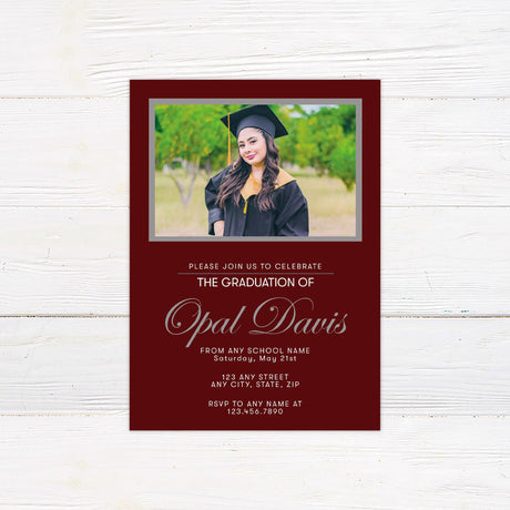 A customizable graduation invitation featuring a solid color frame design. The front includes a personalized photo at the top with the graduate’s name and event details below in an elegant script font. The back contains additional photos and a matching color scheme. The invitation color can be customized to coordinate with the school or event theme. Maroon.