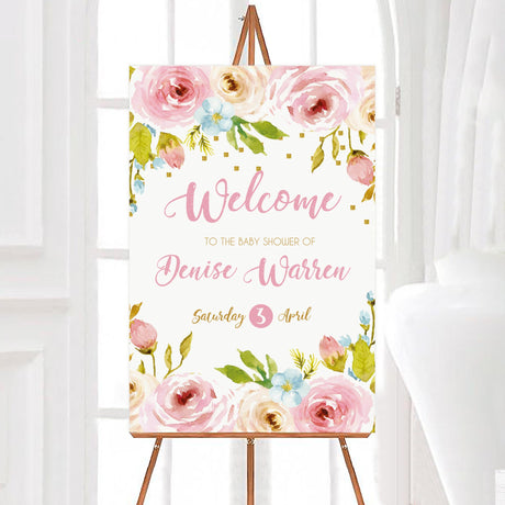 A floral spring blossoms baby shower welcome sign with pink flowers and greenery. The design includes soft watercolor details.