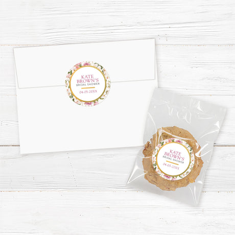 Round bridal shower sticker featuring soft pink and white floral designs with gold accents, customizable with the bride’s name and event date. Perfect for favor packaging, envelope seals, and gift tags.