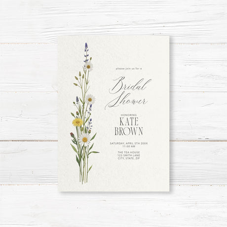 Minimalist bridal shower invitation featuring delicate wildflowers and elegant script typography. Customizable with the bride’s name and event details, perfect for rustic or garden-themed showers.