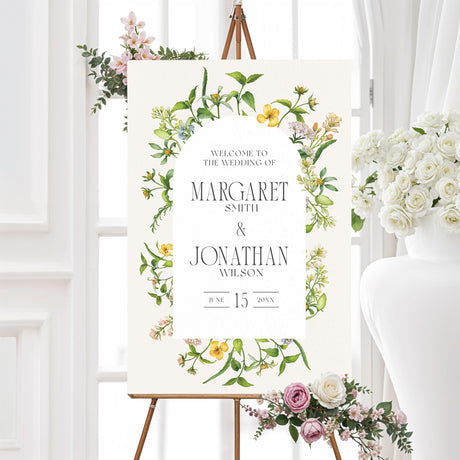 Elegant wedding welcome sign featuring a romantic watercolor floral arch with delicate yellow and green wildflowers. A warm and inviting design to greet guests at the ceremony or reception.