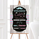 A stashes or lashes gender reveal welcome sign with a mustache and eyelashes. The design uses pink and teal colors on a dark background.