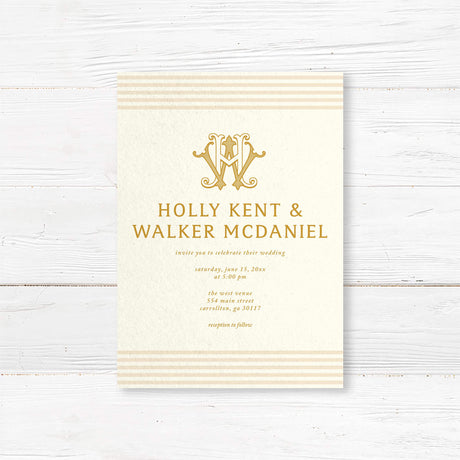 Elegant cream and gold wedding invitation featuring a decorative gold monogram crest at the top, horizontal neutral stripes on the top and bottom edges, and classic serif typography, ideal for formal weddings.